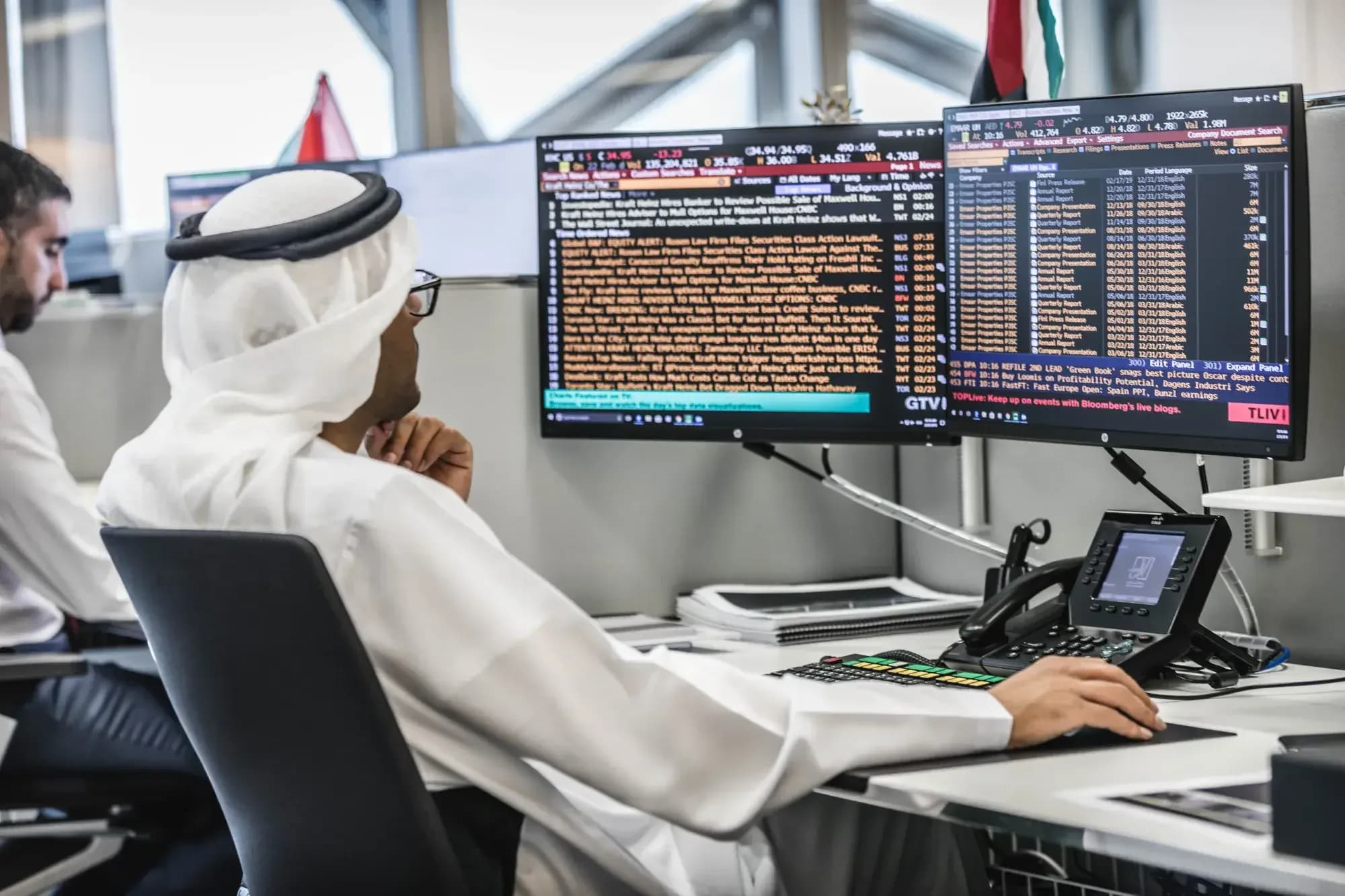 Emirati trader at Bloomberg terminal — Al-Fardan Q9 OTC desk